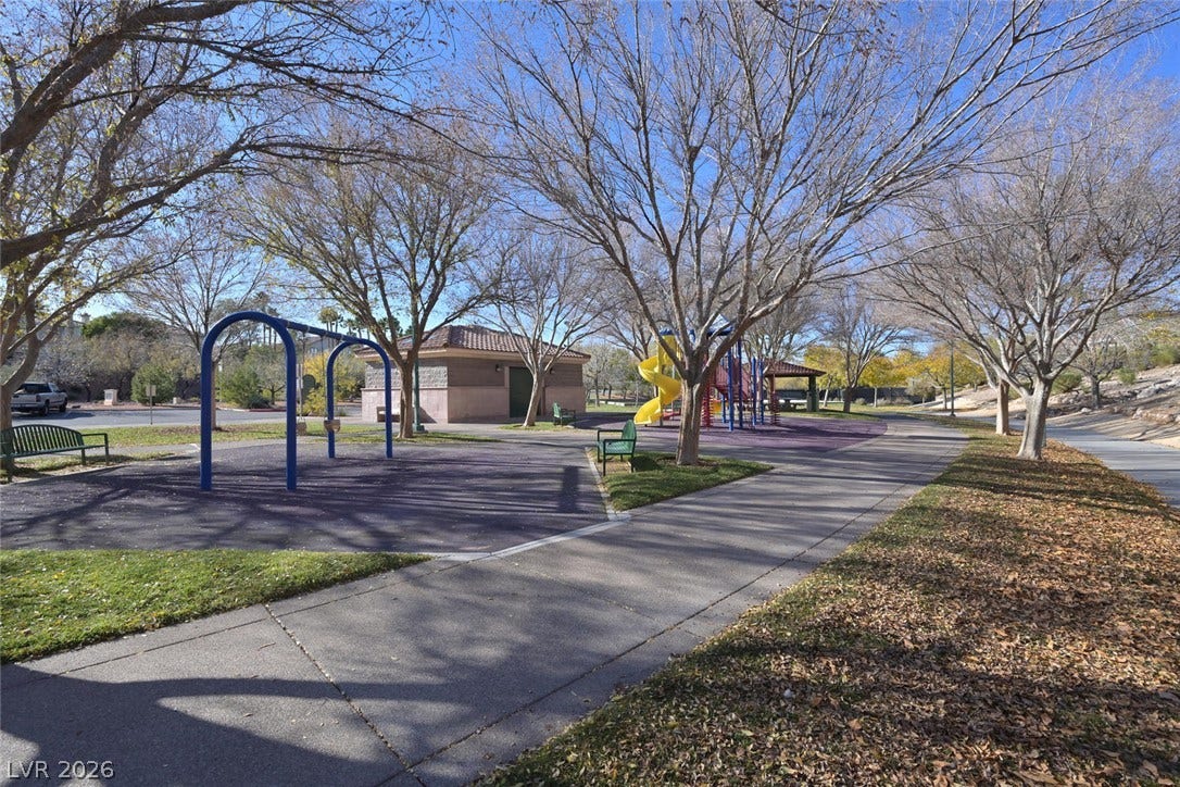 1421 Dragon Rock Drive, Henderson, NV 89052 A winding concrete pathway leads directly to the neighborhood playground surrounded by mature trees.
