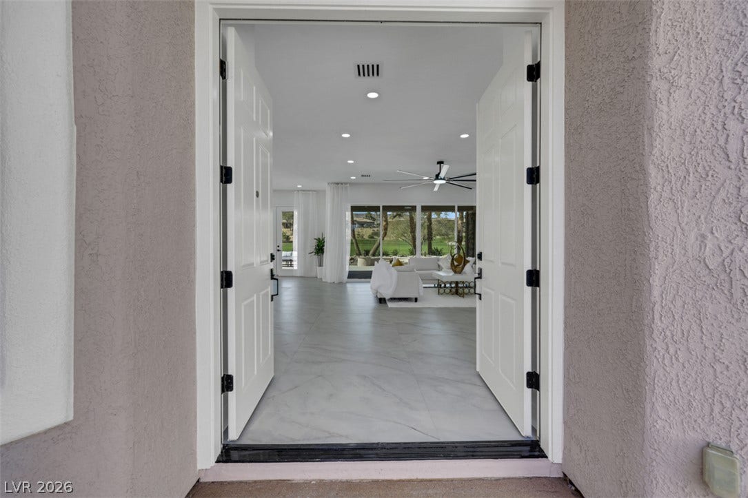 5015 Rivedro Street, Las Vegas, NV 89135 Double doors open to reveal an expansive open layout with polished tile flooring throughout.