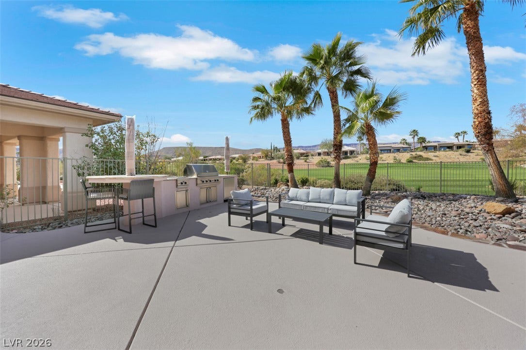 5015 Rivedro Street, Las Vegas, NV 89135 An outdoor kitchen and concrete patio look out onto the adjacent golf course.
