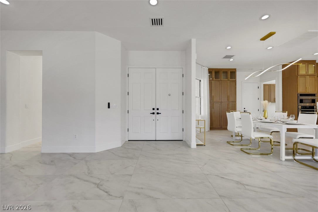 5015 Rivedro Street, Las Vegas, NV 89135 Polished tile flooring and clean architectural lines define this welcoming entryway and dining space.