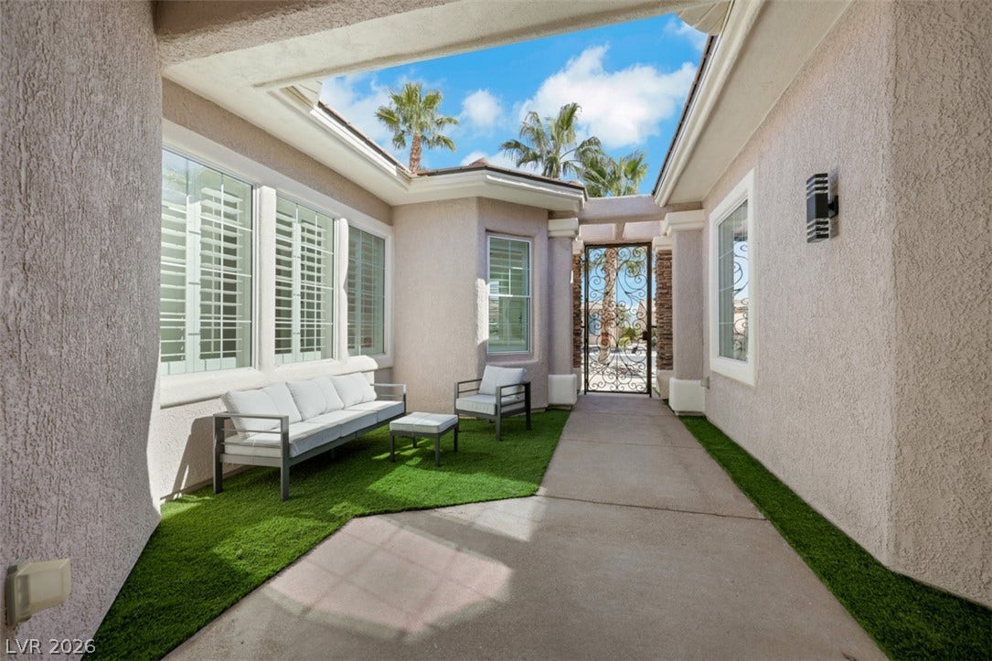 5015 Rivedro Street, Las Vegas, NV 89135 An inviting gated entry courtyard leads past oversized windows into the home.
