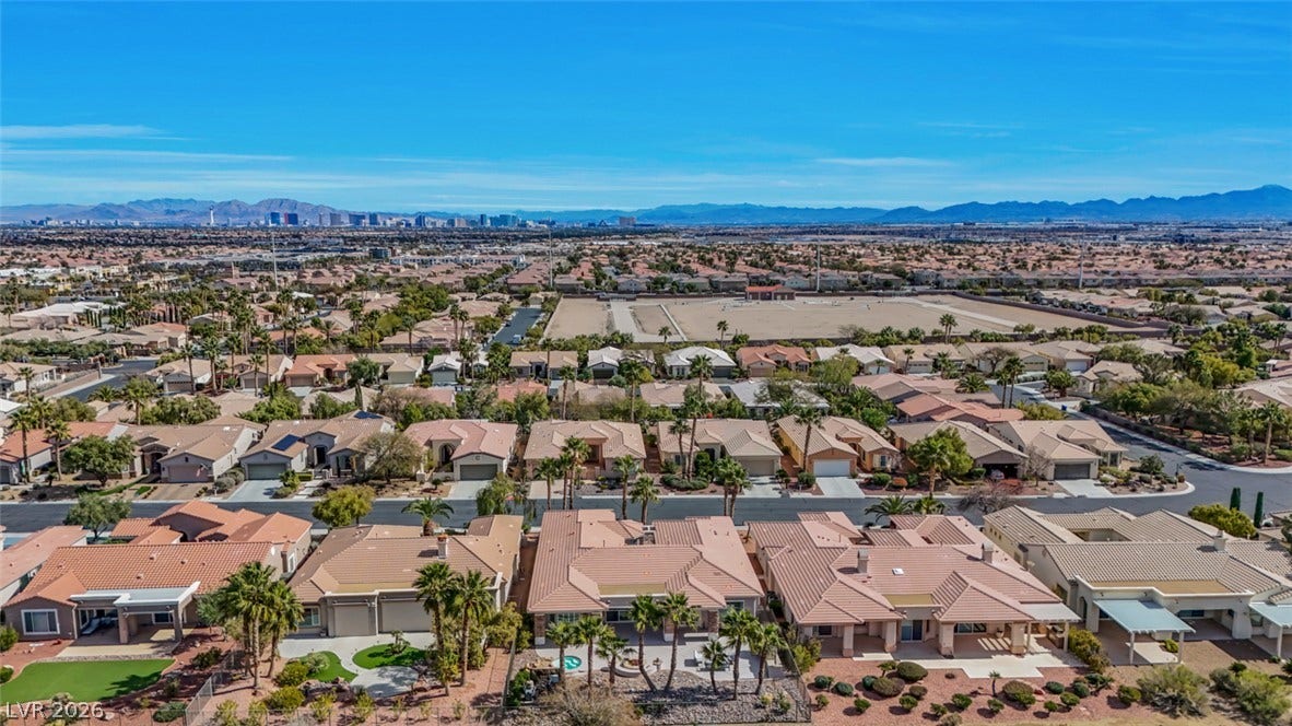 5015 Rivedro Street, Las Vegas, NV 89135 Panoramic mountain and skyline views overlook this sprawling suburban desert neighborhood under clear blue skies.