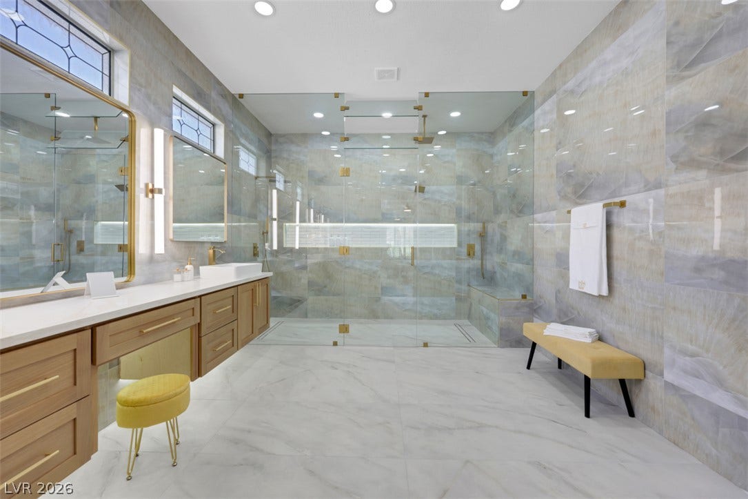 5015 Rivedro Street, Las Vegas, NV 89135 Gleaming marble flooring and a massive glass-enclosed shower define this luxurious bathroom retreat.
