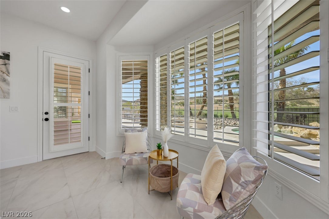 5015 Rivedro Street, Las Vegas, NV 89135 Gleaming tile floors and custom plantation shutters frame beautiful backyard views from this sunny nook.