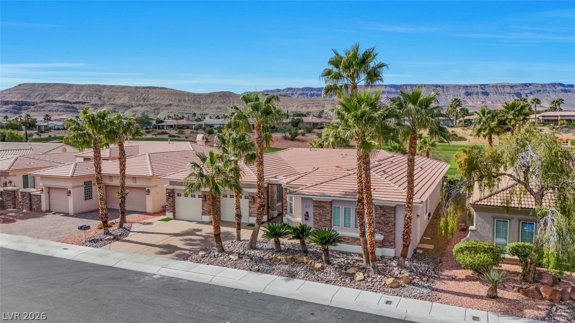 5015 Rivedro Street, Las Vegas, NV 89135 Spanish tile roofs and stone accents define this single-level desert home set against mountain views.