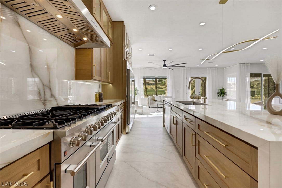 5015 Rivedro Street, Las Vegas, NV 89135 Gleaming stone surfaces and custom wood cabinetry define this highly functional culinary space.