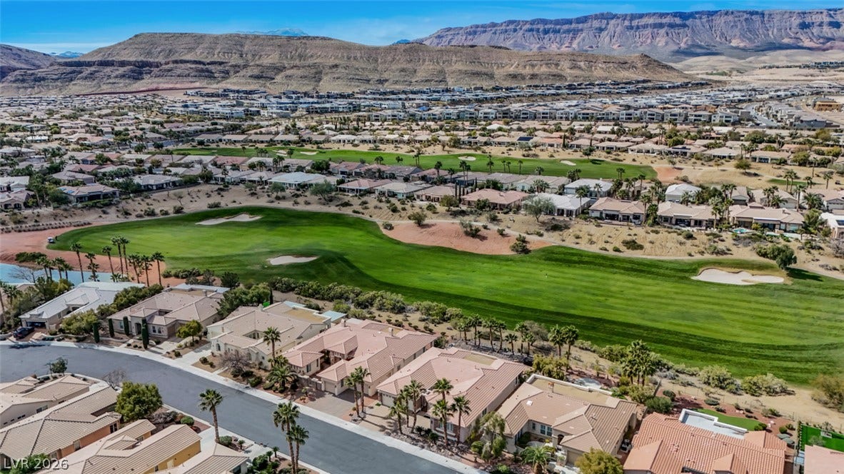 5015 Rivedro Street, Las Vegas, NV 89135 Dramatic mountain vistas rise behind the lush fairways of this desert community.