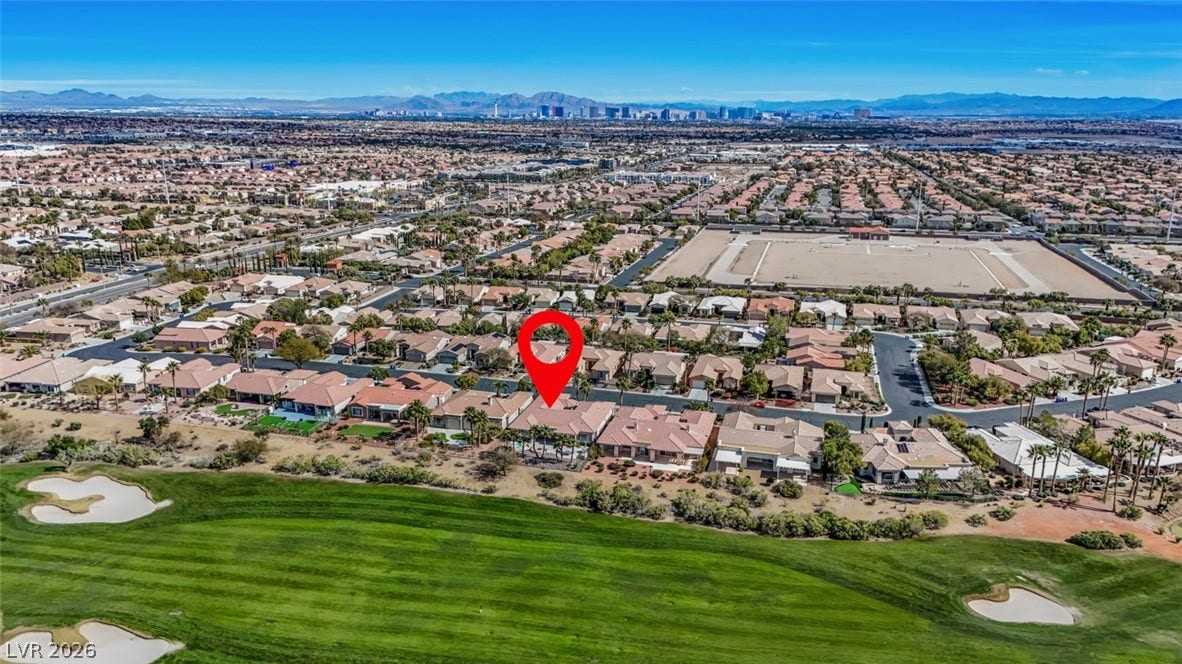 5015 Rivedro Street, Las Vegas, NV 89135 Panoramic mountain and skyline views overlook a manicured green fairway under clear blue skies.