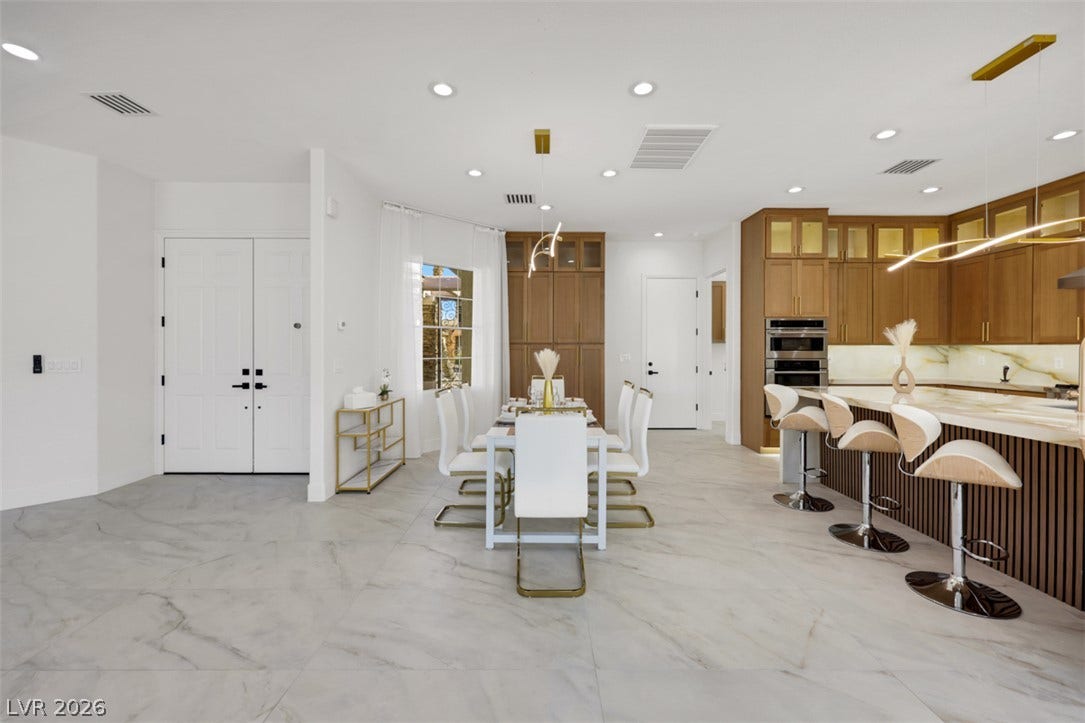 5015 Rivedro Street, Las Vegas, NV 89135 Polished tile flooring and an open layout seamlessly connect the dining space and kitchen.