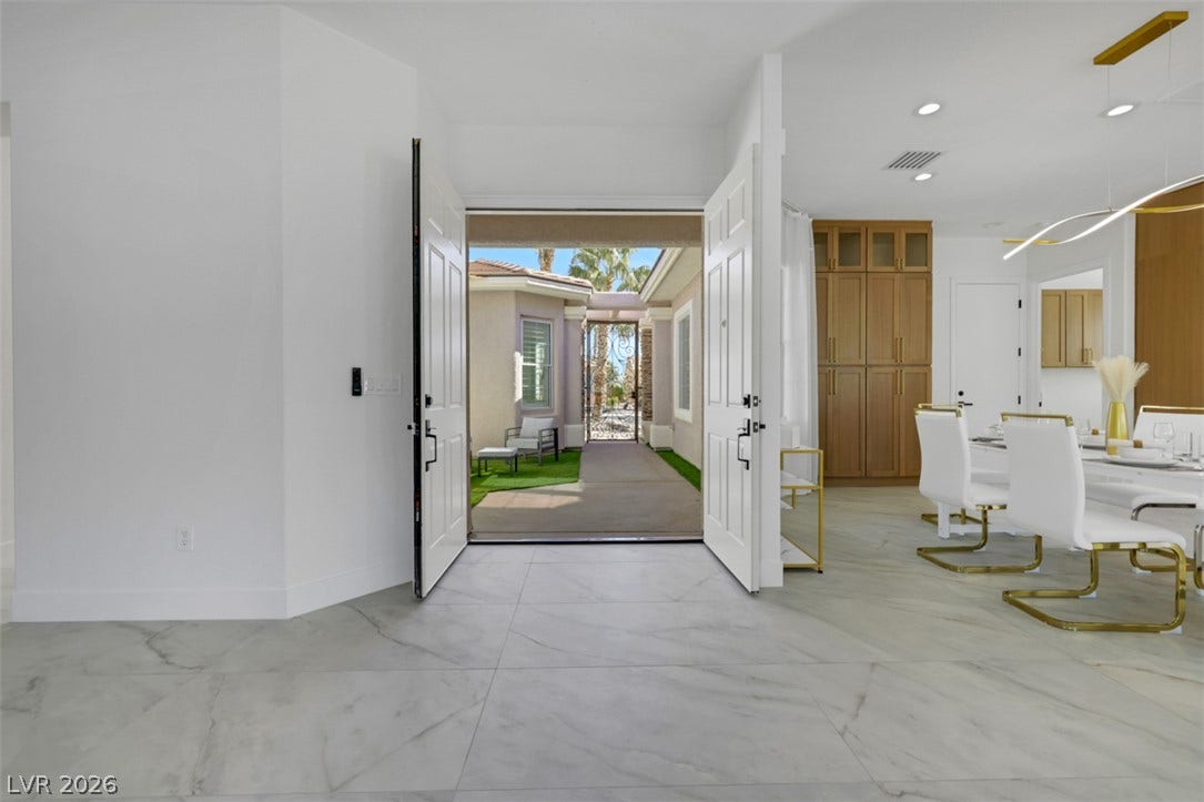 5015 Rivedro Street, Las Vegas, NV 89135 Double entry doors open to a courtyard view, highlighting polished tile flooring and clean lines.
