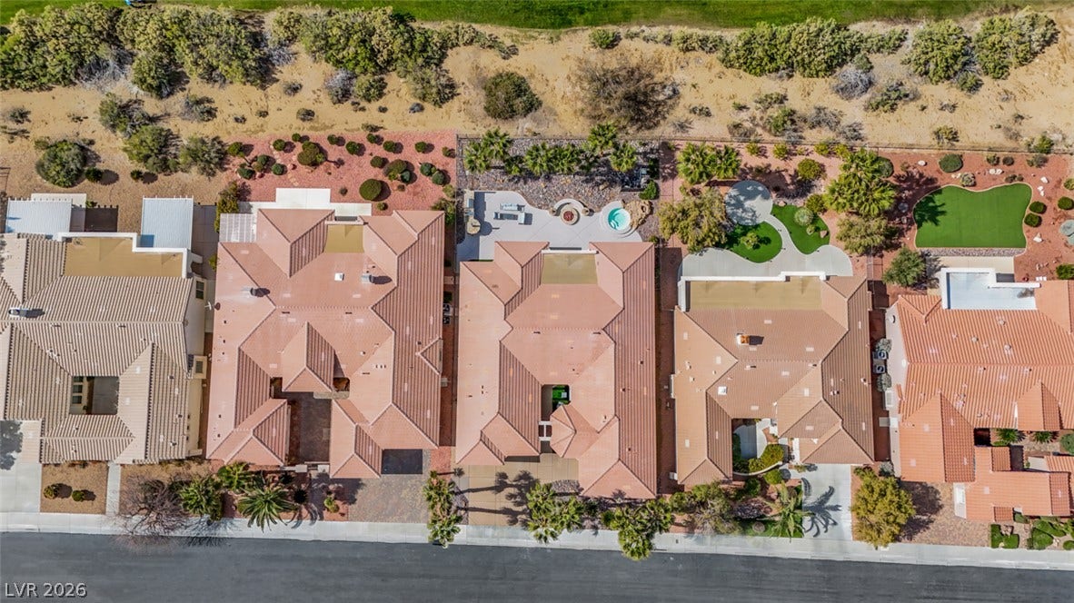 5015 Rivedro Street, Las Vegas, NV 89135 An aerial perspective shows desert-style homes with tile roofing and private backyards.