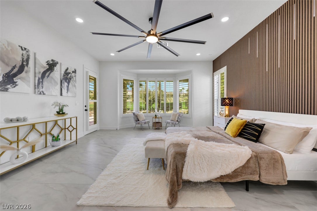 5015 Rivedro Street, Las Vegas, NV 89135 A spacious main bedroom captures peaceful golf course views through a classic bay window.
