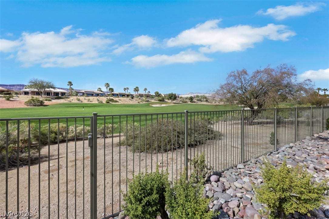 5015 Rivedro Street, Las Vegas, NV 89135 A metal fence frames sweeping green fairways under open desert skies.