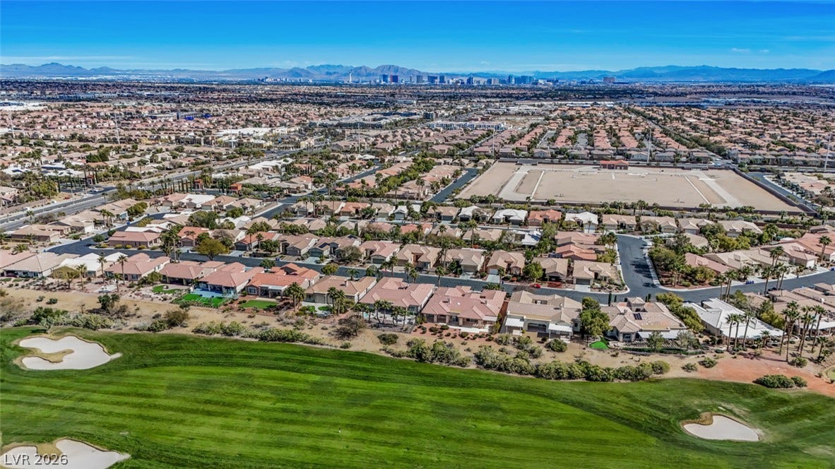5015 Rivedro Street, Las Vegas, NV 89135 An aerial perspective showcases a premier residential neighborhood bordering a green golf course.
