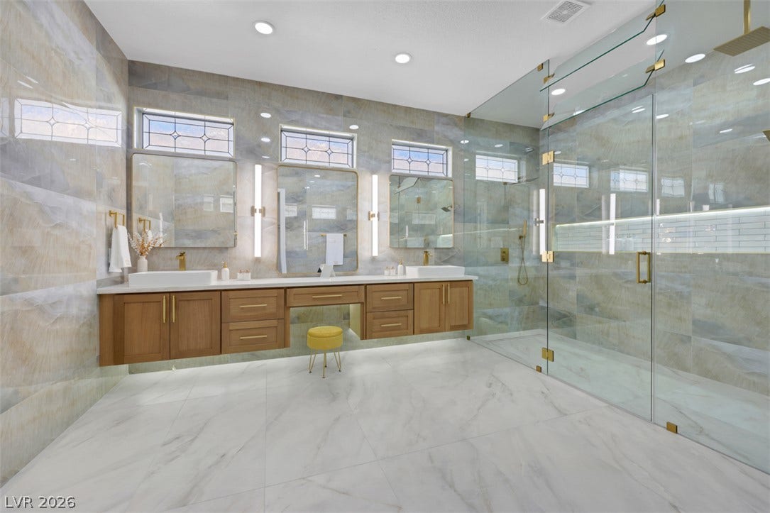 5015 Rivedro Street, Las Vegas, NV 89135 Gleaming marble-patterned tile floors and fully tiled walls frame this luxurious bath oasis.