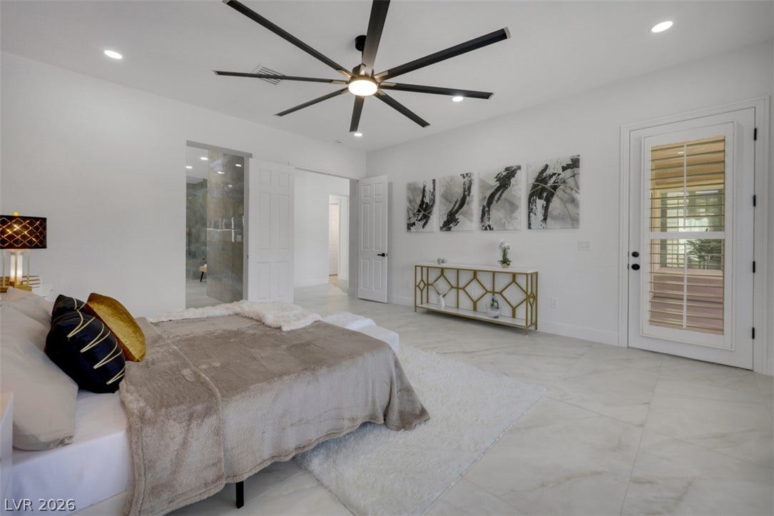 5015 Rivedro Street, Las Vegas, NV 89135 Polished tile flooring and integrated lighting highlight this airy bedroom design.