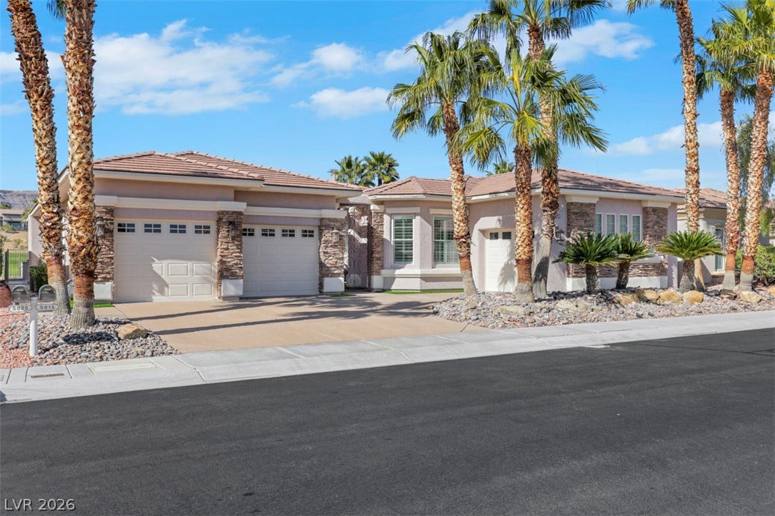 5015 Rivedro Street, Las Vegas, NV 89135 Palm trees frame the stone-accented facade of this elegant single-level home.