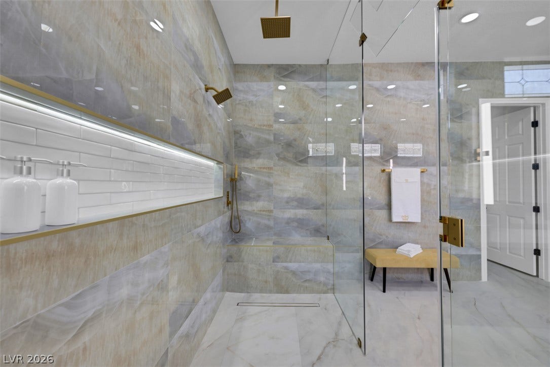 5015 Rivedro Street, Las Vegas, NV 89135 Floor-to-ceiling tile surrounds a spacious walk-in shower with high-end fixtures and glass doors.