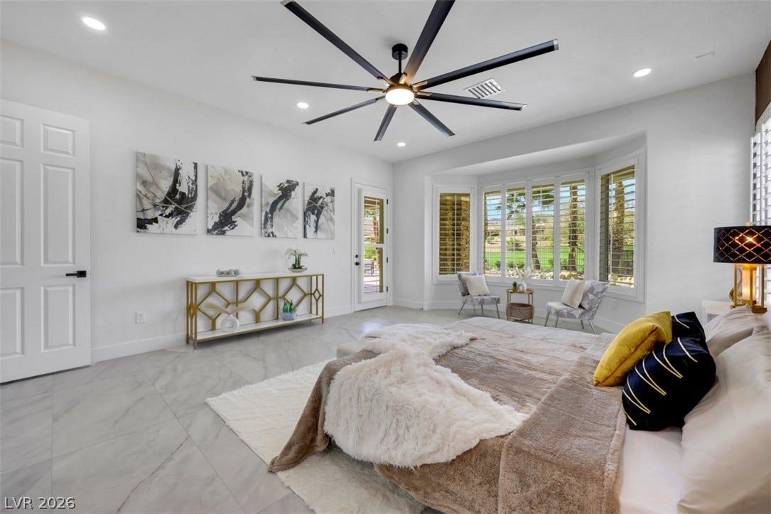 5015 Rivedro Street, Las Vegas, NV 89135 Elegant tile flooring and a sunny bay window elevate this restful bedroom retreat.
