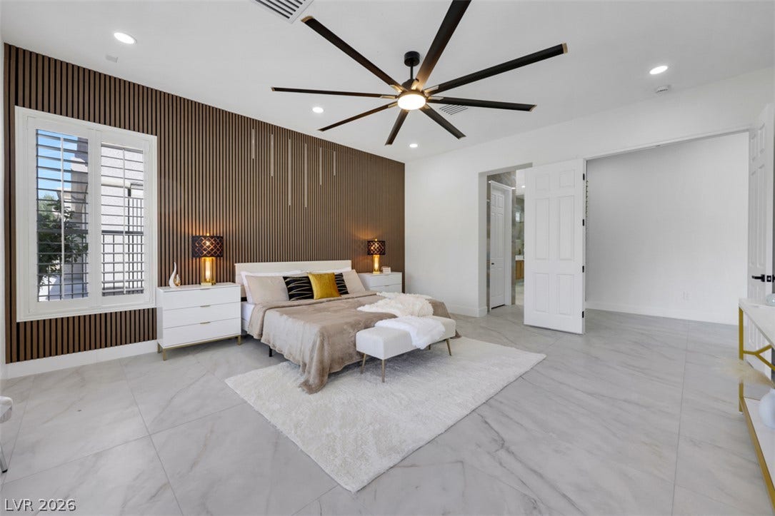 5015 Rivedro Street, Las Vegas, NV 89135 Gleaming tile floors and vertical wood paneling define this generous primary suite.