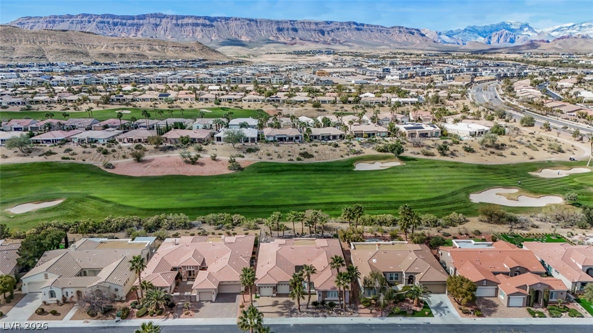 5015 Rivedro Street, Las Vegas, NV 89135 Dramatic mountain ridges frame this expansive neighborhood bordering a manicured green fairway.