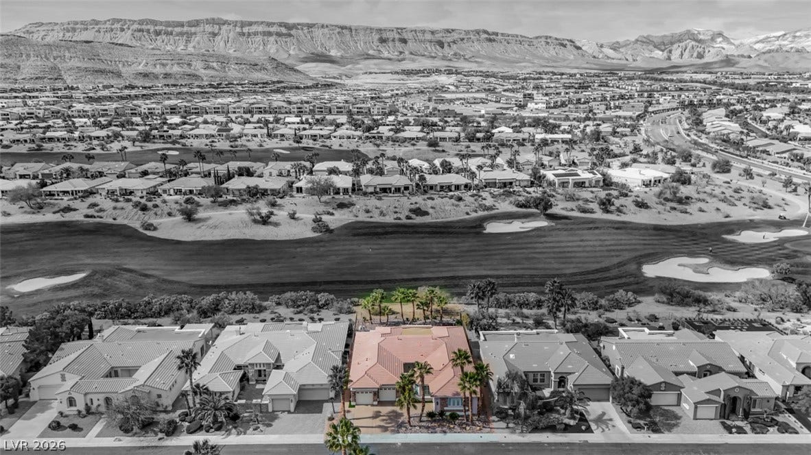 5015 Rivedro Street, Las Vegas, NV 89135 Dramatic mountain backdrops and a lush golf course frame this exceptional desert property.