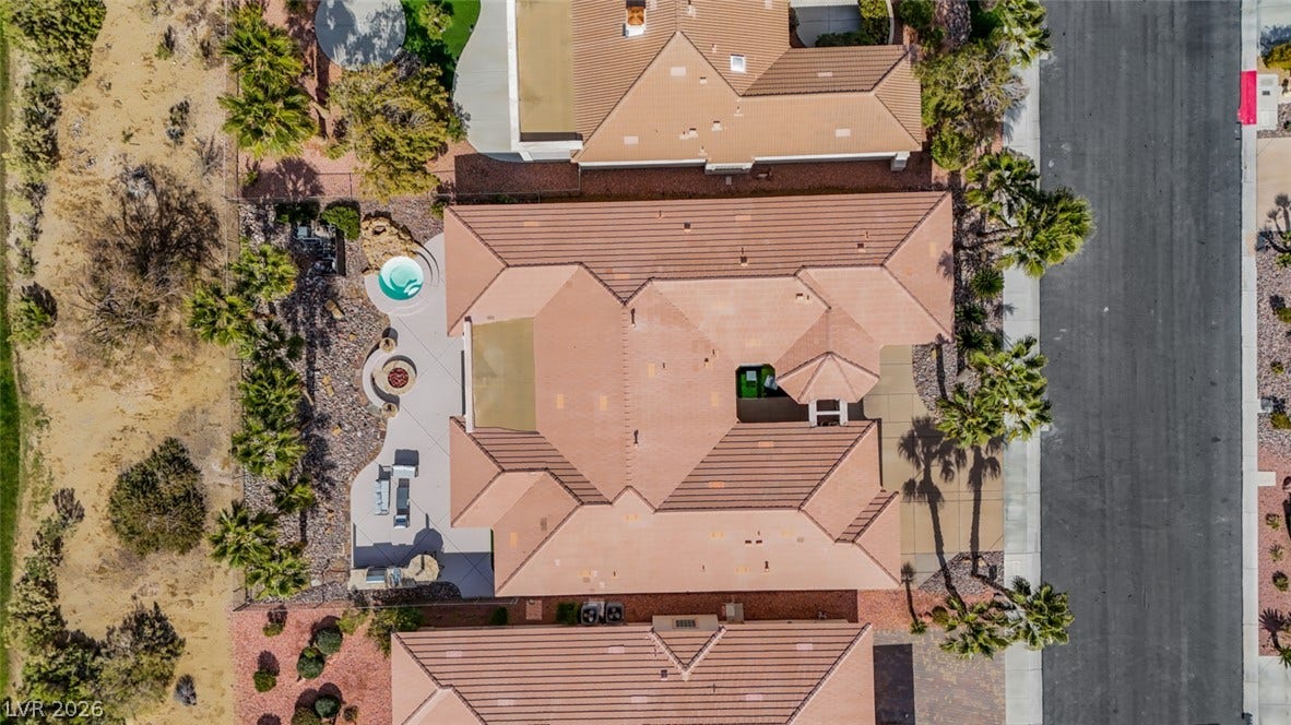 5015 Rivedro Street, Las Vegas, NV 89135 An aerial perspective showcases the classic tile roof architecture and private backyard oasis.
