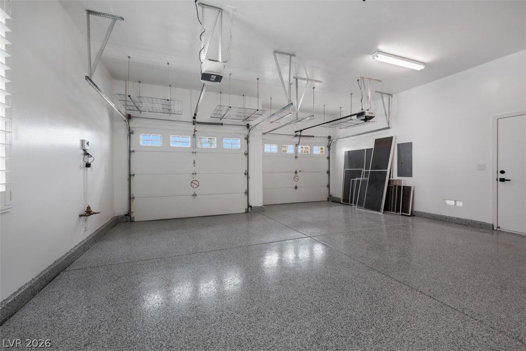 5015 Rivedro Street, Las Vegas, NV 89135 An immaculate three-car garage features durable epoxy-coated flooring and overhead storage racks.