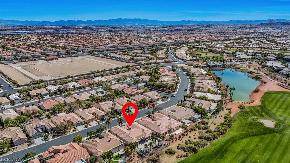 5015 Rivedro Street, Las Vegas, NV 89135 An expansive neighborhood panorama showcases a master-planned community bordering a golf course and lake.