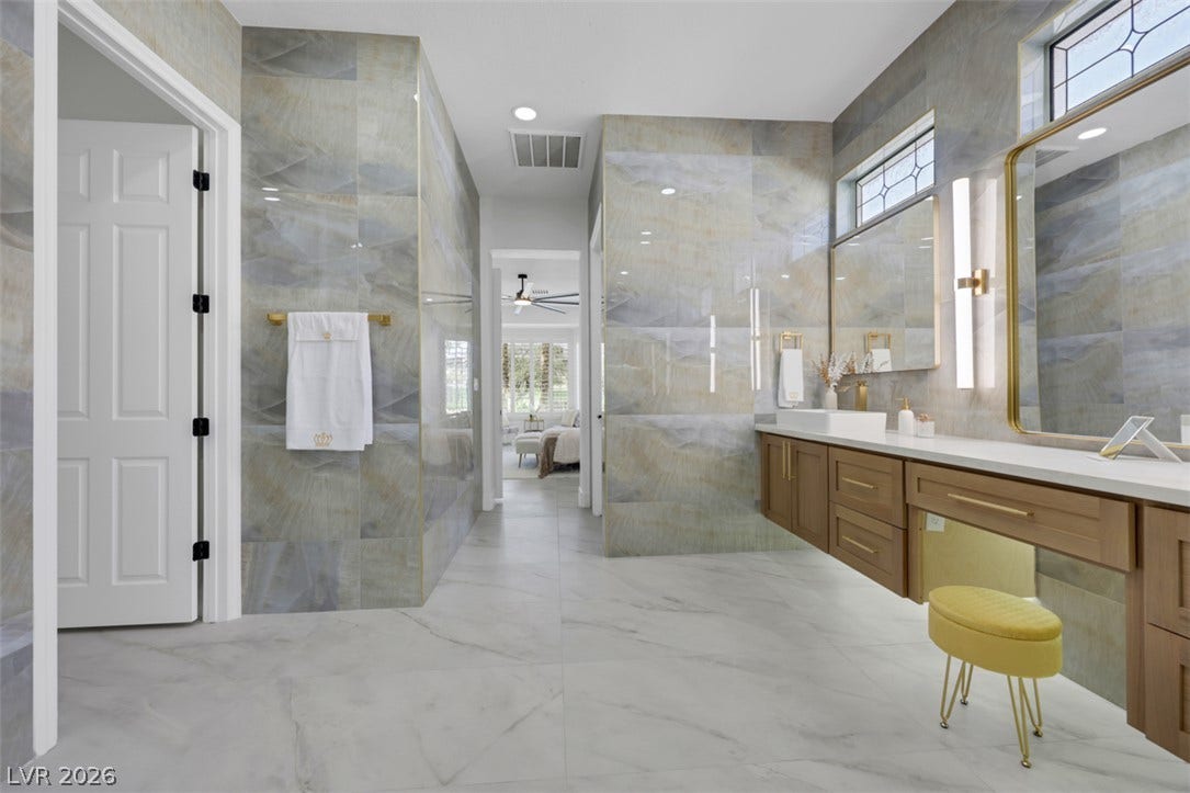 5015 Rivedro Street, Las Vegas, NV 89135 Gleaming tile walls and stone floors elevate this refined master bathroom design.