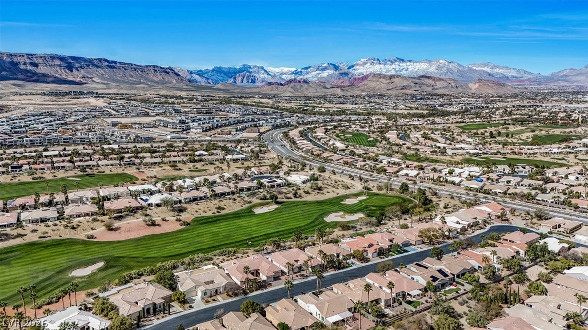 5015 Rivedro Street, Las Vegas, NV 89135 Dramatic mountain peaks frame a sprawling valley community featuring lush fairways and scenic neighborhoods.
