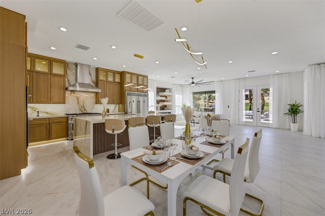 5015 Rivedro Street, Las Vegas, NV 89135 Gleaming stone tile flooring sweeps through an airy open-plan kitchen and dining area.