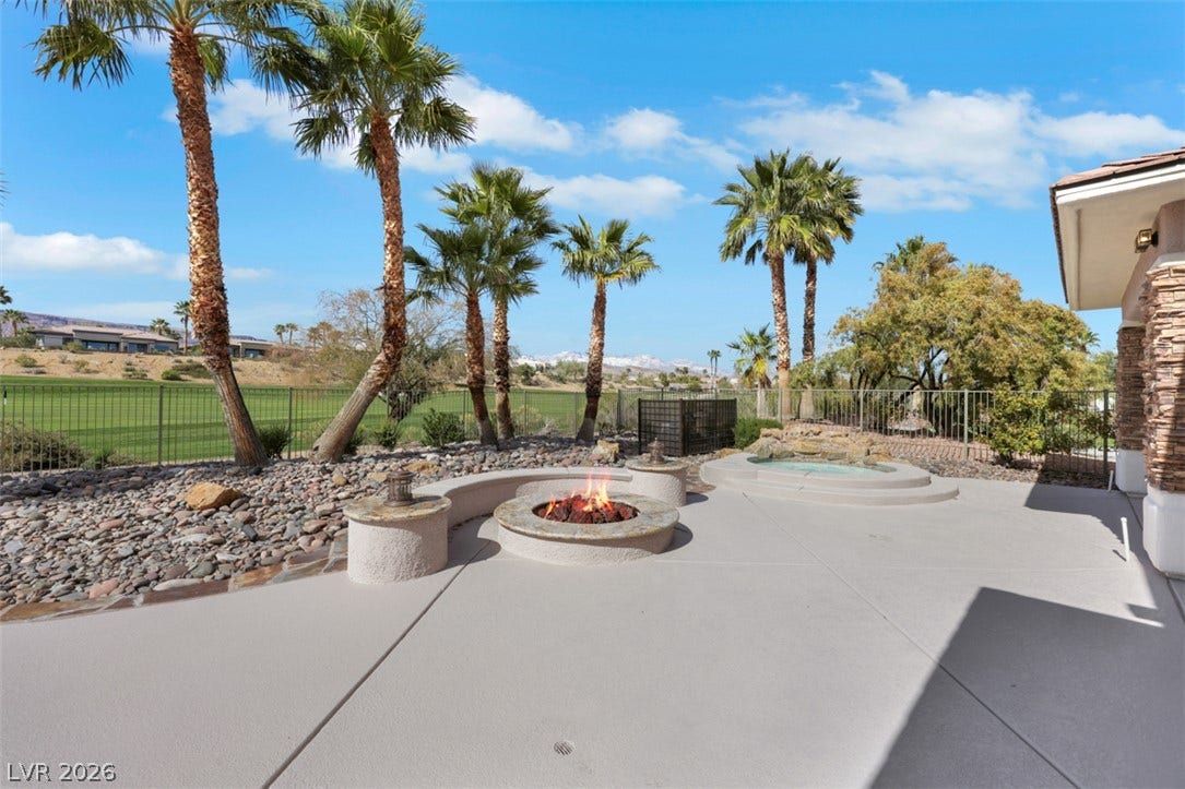 5015 Rivedro Street, Las Vegas, NV 89135 A stone fire pit and private spa highlight this concrete patio overlooking the golf course.