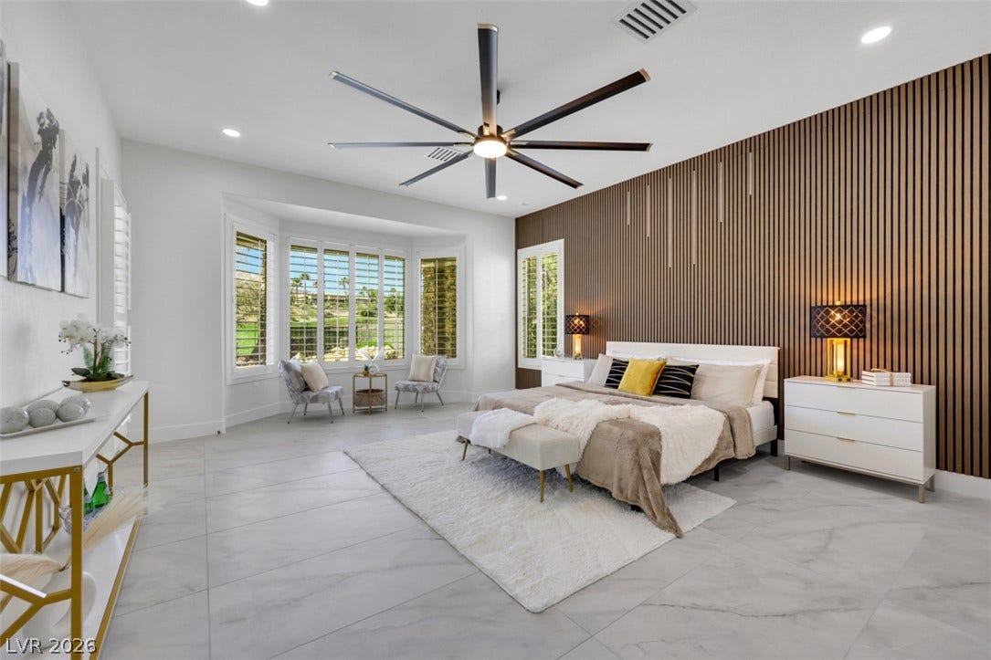 5015 Rivedro Street, Las Vegas, NV 89135 Clean tile flooring and a wood slat accent wall define this serene sleeping space.