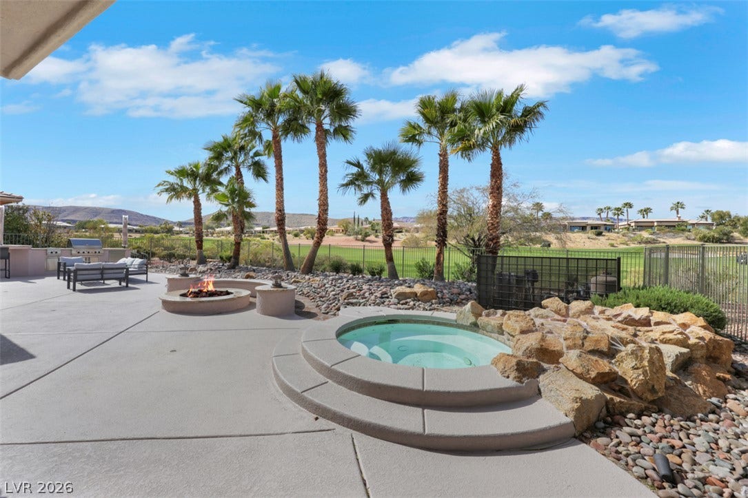 5015 Rivedro Street, Las Vegas, NV 89135 An inviting outdoor spa and fire pit overlook the lush golf course greens.