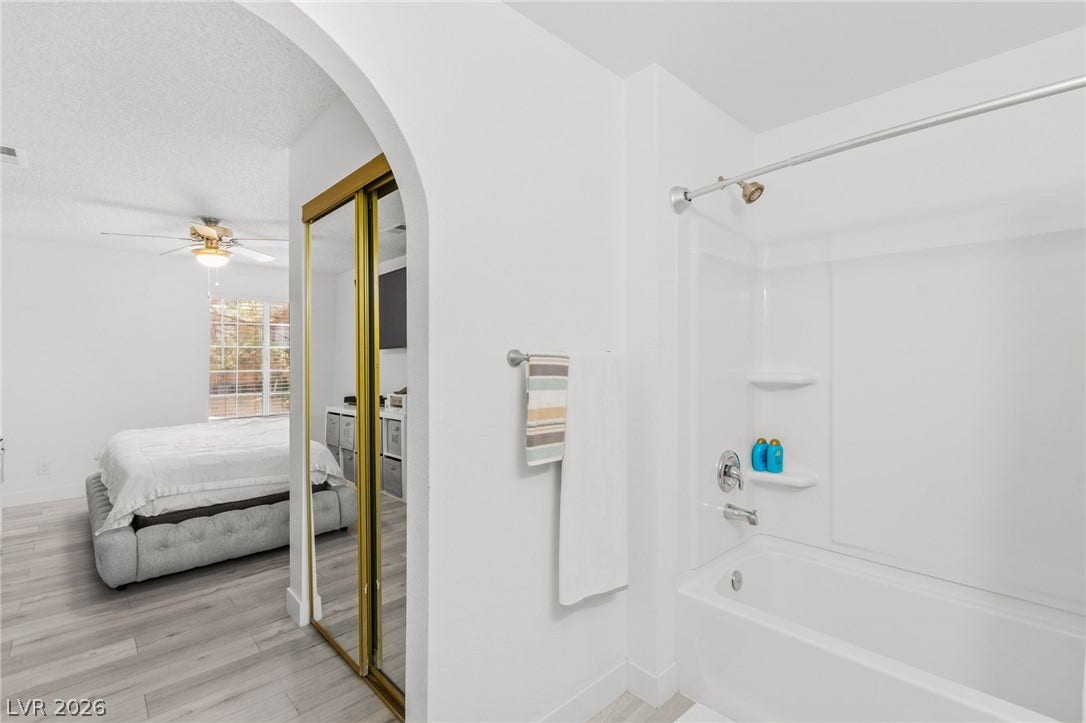 2200 S Fort Apache Road, #2156, Las Vegas, NV 89117 The bathroom features a pristine white shower and tub combination, offering a fresh, clean aesthetic.