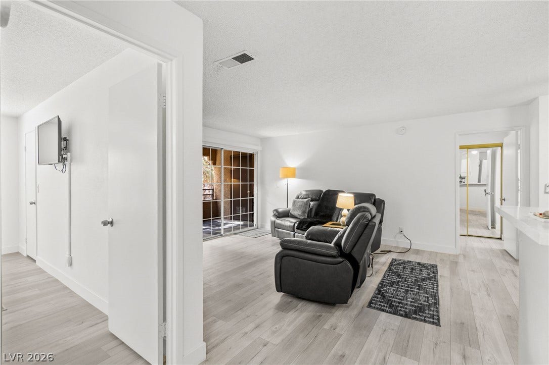 2200 S Fort Apache Road, #2156, Las Vegas, NV 89117 Bright, open living area featuring sliding glass doors to a private balcony.