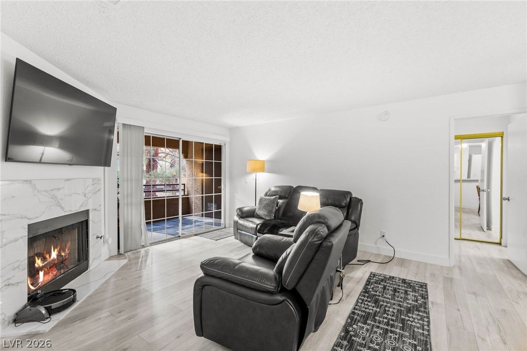 2200 S Fort Apache Road, #2156, Las Vegas, NV 89117 A marble-clad fireplace creates a warm focal point in this inviting living space.