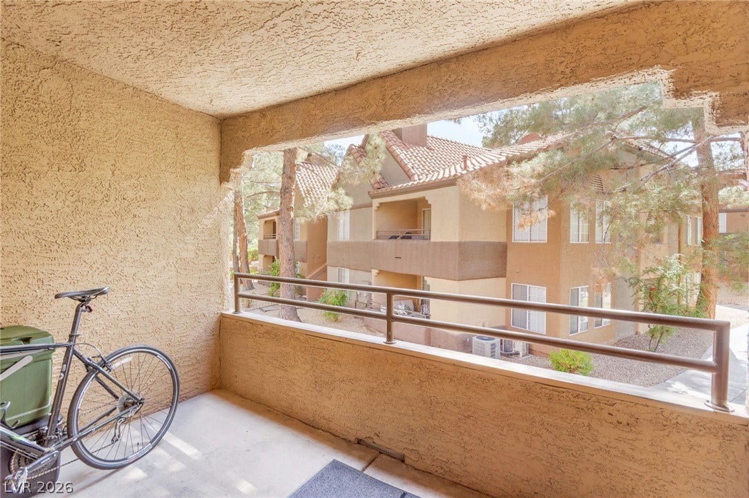 2200 S Fort Apache Road, #2156, Las Vegas, NV 89117 A well-proportioned balcony offers a quiet retreat with views of the community buildings and surrounding foliage.