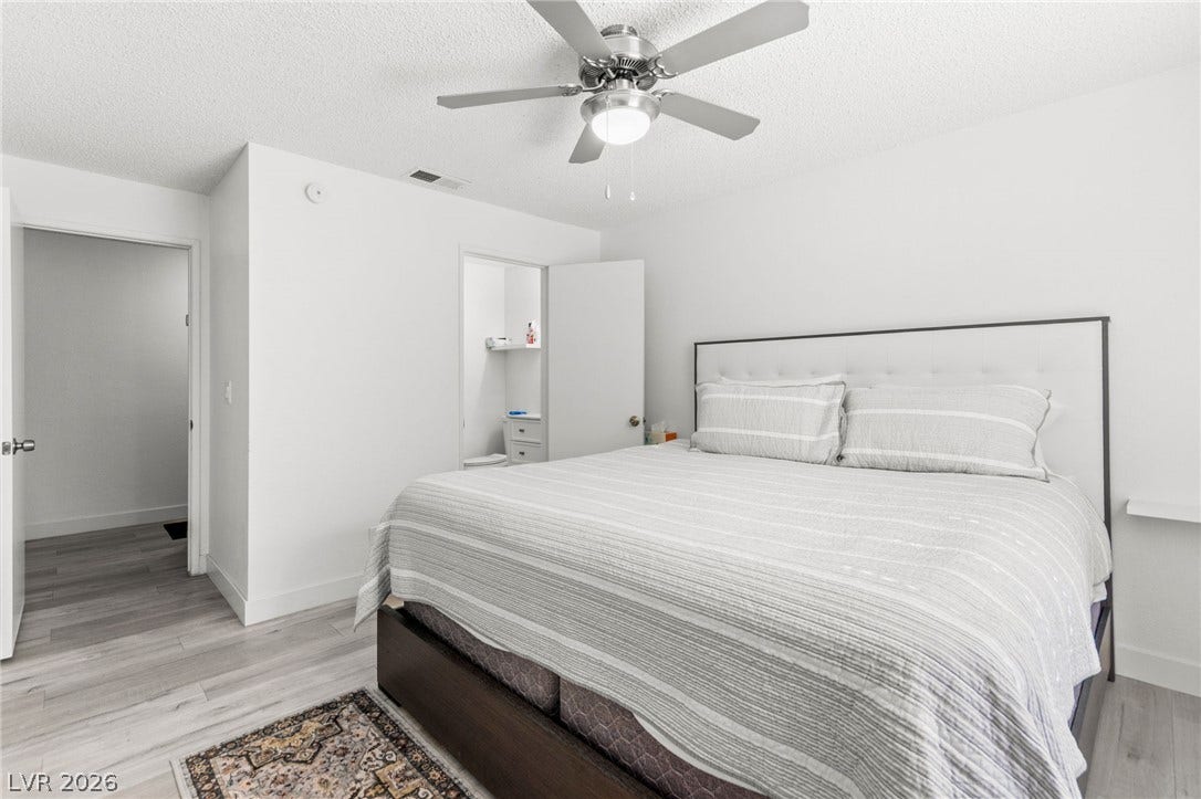 2200 S Fort Apache Road, #2156, Las Vegas, NV 89117 Streamlined primary bedroom with cool-toned flooring and an efficient overhead ceiling fan.