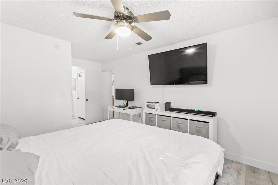 2200 S Fort Apache Road, #2156, Las Vegas, NV 89117 Relax in this well-lit bedroom featuring practical light wood flooring and convenient ceiling fan for comfort.