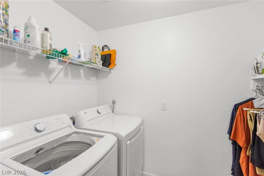 2200 S Fort Apache Road, #2156, Las Vegas, NV 89117 Functional laundry space featuring modern appliances and convenient wire shelving for storage.
