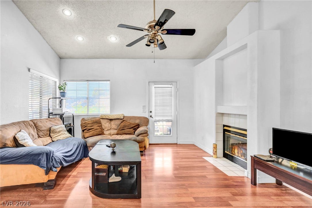 Gleaming hardwood floors and a cozy fireplace define this comfortable living space.