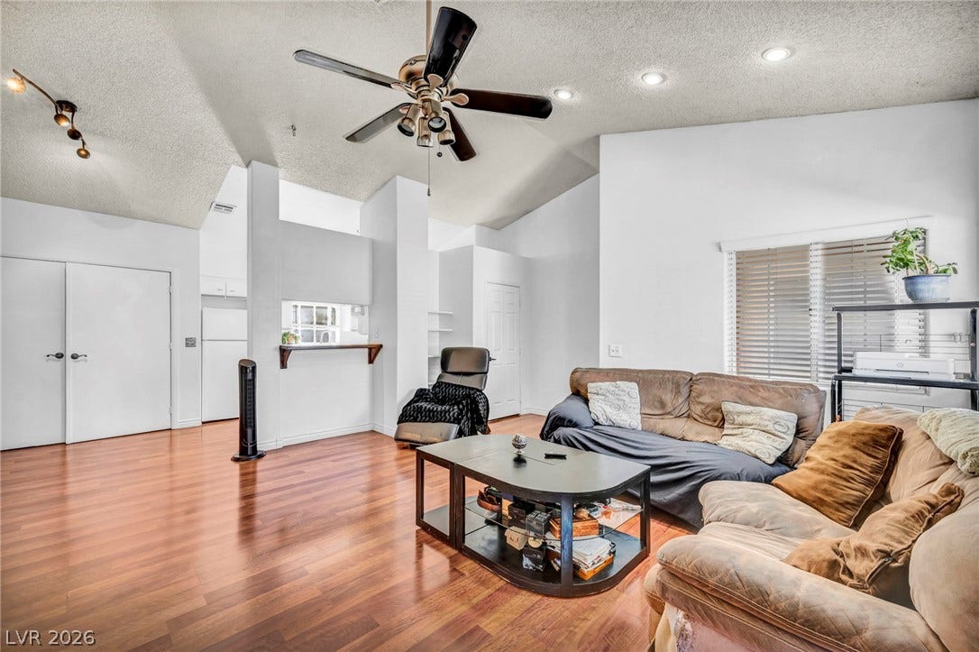 Soaring vaulted ceilings and warm wood floors define this welcoming main living area.