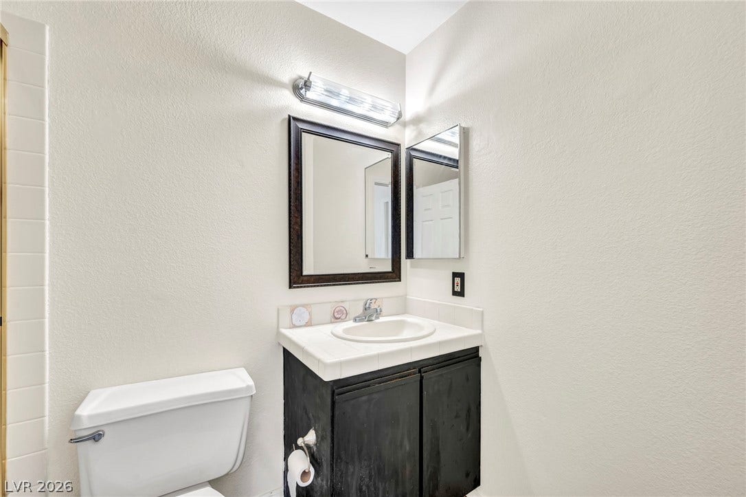 Clean lines and classic tiling define this well-appointed half bathroom vanity space.