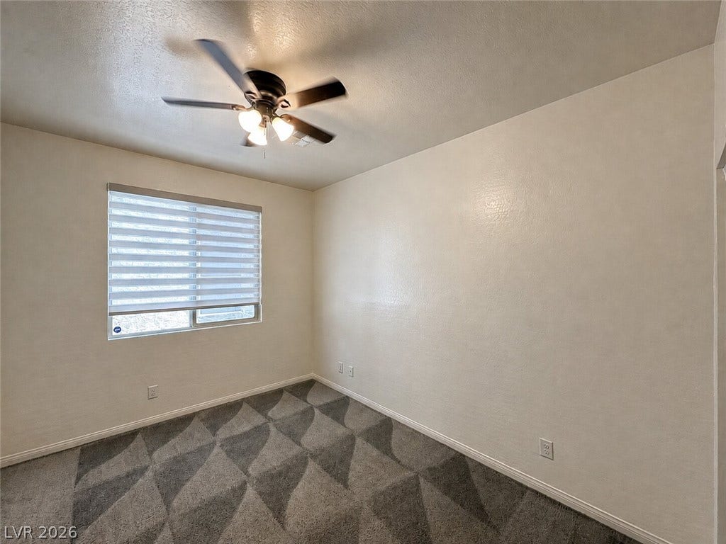 Patterned carpeting and plaster-texture walls define this versatile interior space.