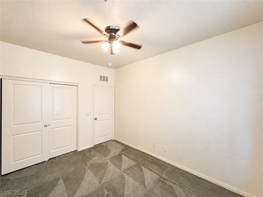 Soft carpeting underfoot defines this versatile secondary bedroom space.