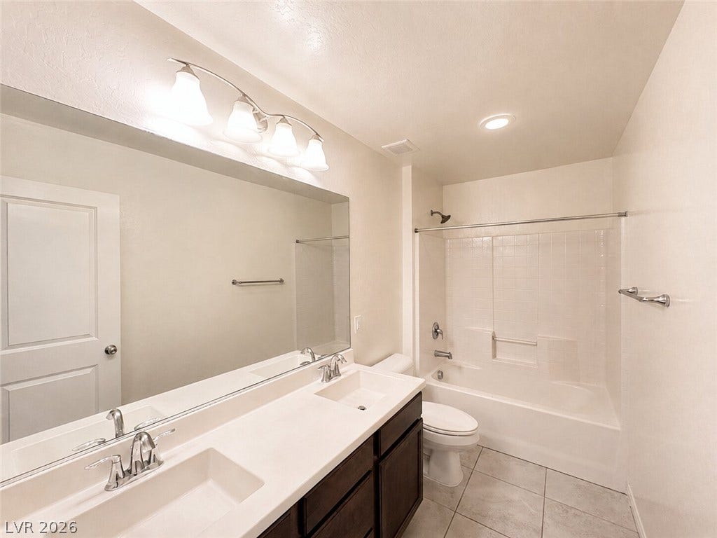 A spacious double vanity and a clean tub shower combination define this bathroom design.