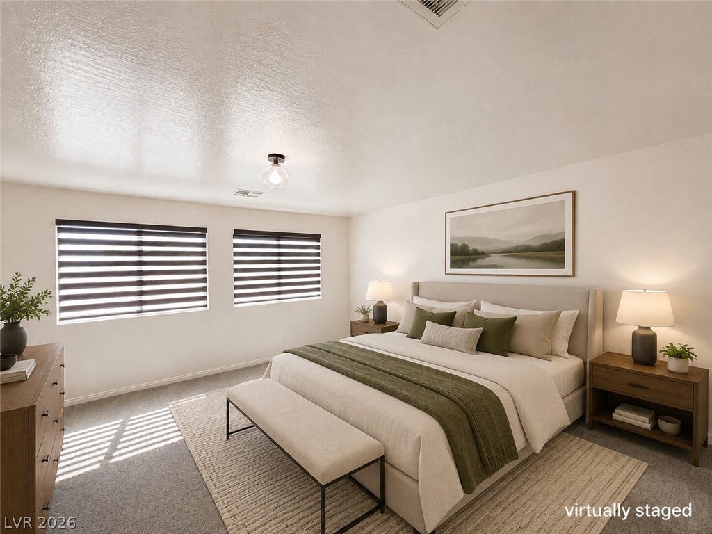 Natural light pours through dual windows in this peaceful bedroom with plush carpeting.