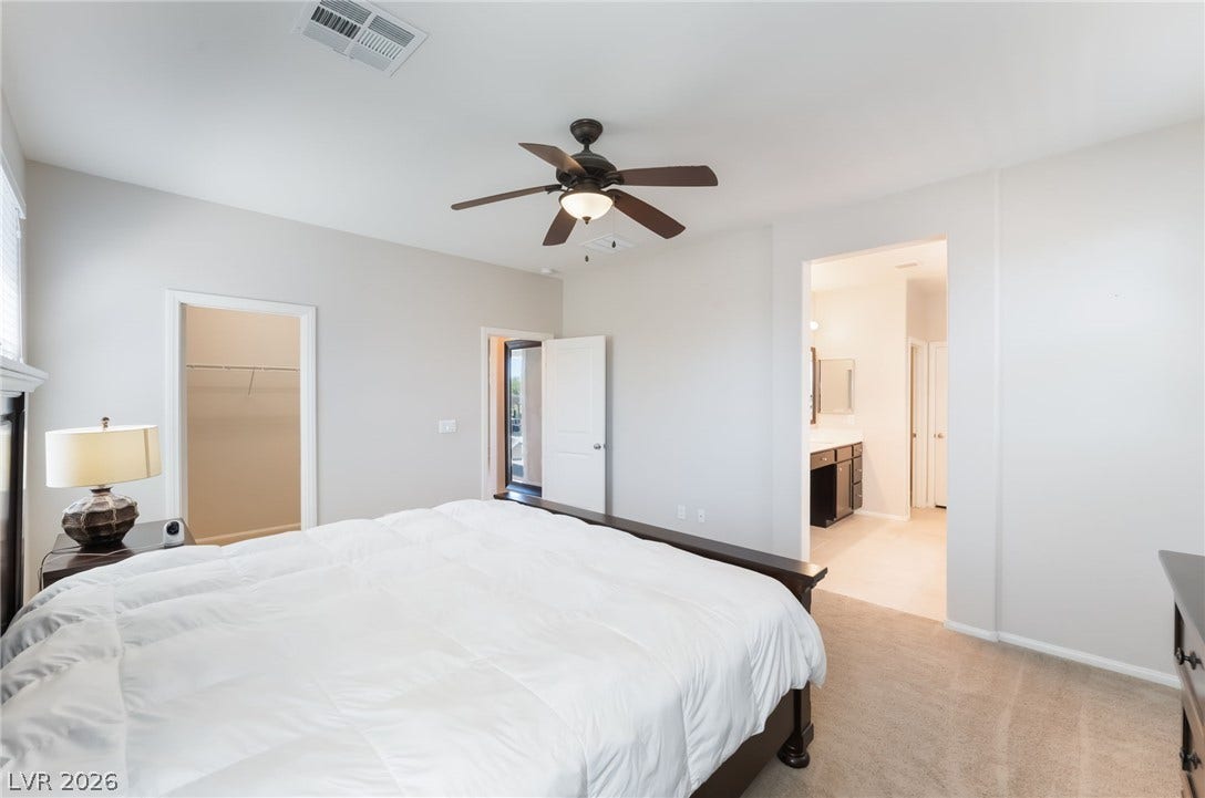 Plush carpeting and an open layout connect the sleeping quarters to an adjoining bath.